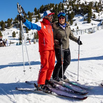 Moniteur de ski avec un skieur adulte